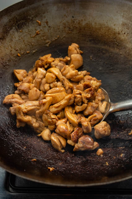 cooking teriyaki chicken in a wok