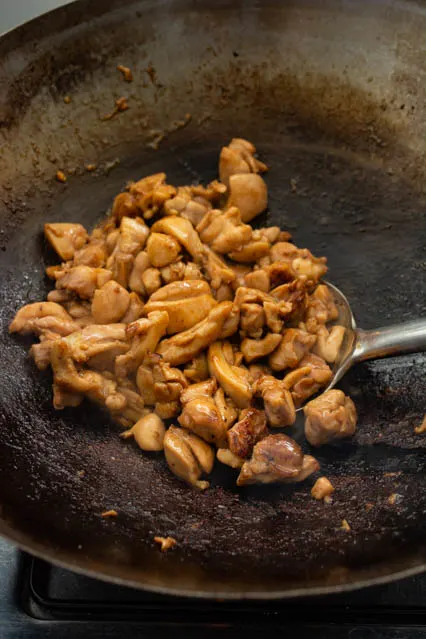 cooking teriyaki chicken in a wok