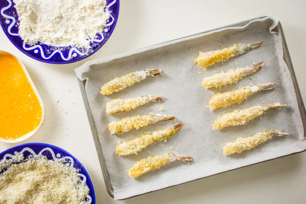 uncooked shrimp tempura on baking tray