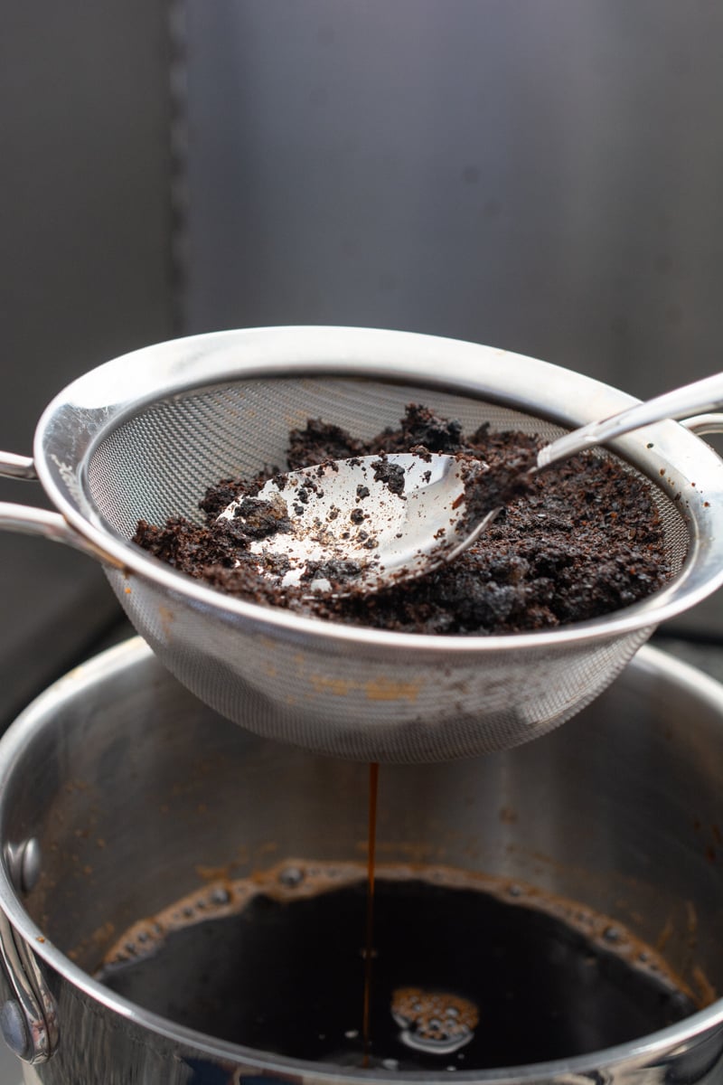 pressing thai tea concentrate through strainer