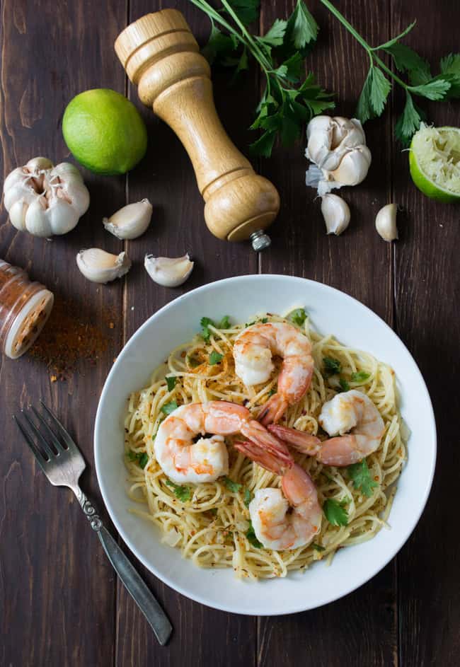 Mojo de Ajo Shrimp Pasta is a Mexican inspired version of Spaghetti aglio e olio. Pasta tossed in Mojo de Ajo (garlic oil), topped with succulent shrimp, chili flakes and fresh parsley or cilantro. 