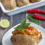 Thai Red Curry Baked Potatoes is an "East Meets West" version of comfort food. Perfect fluffy baked potato topped with a creamy, rich Thai Red Curry with tender chicken and crunchy green beans.