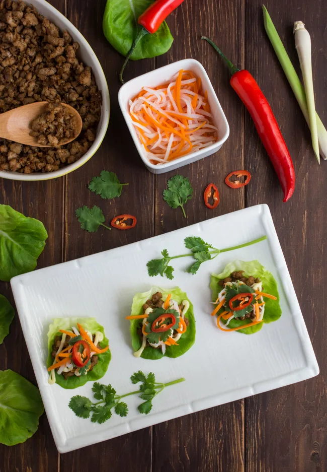 Inspired by Vietnamese Lemongrass Pork Bahn Mi Sandwiches, these Pork Bahn Mi Lettuce Wraps feature a lemongrass pork filling topped with creamy mayonnaise, pickled carrots and daikon, then topped with cilantro and fresh chili.