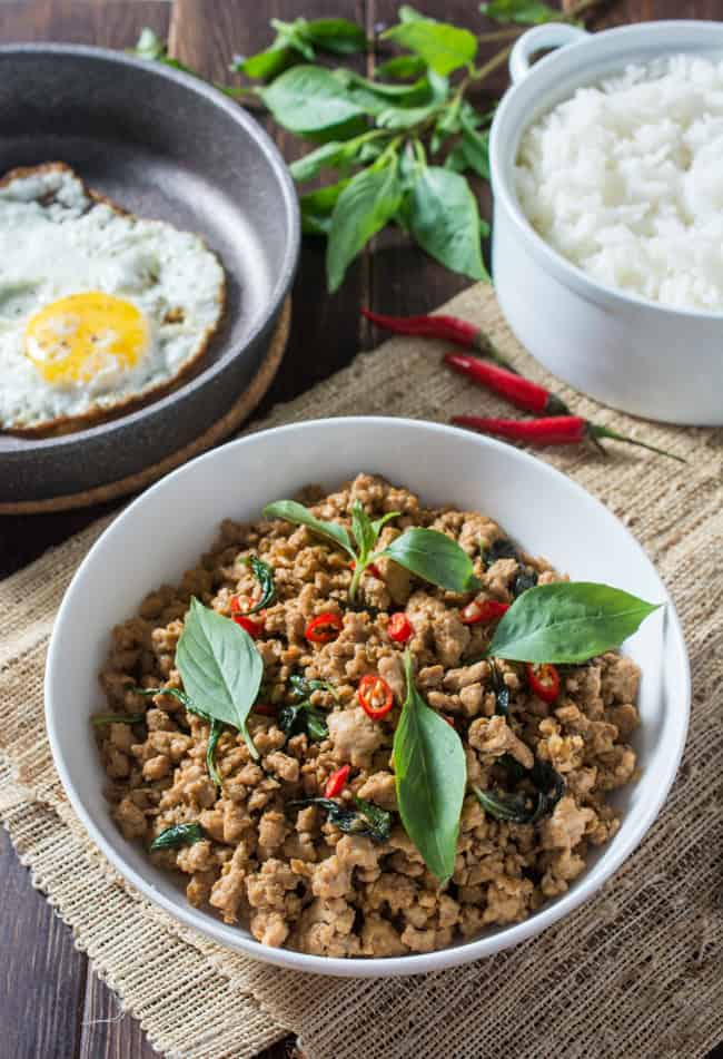 Thai Basil Chicken (Pad Krapow Gai or Gai Pad Krapow) is a classic Thai stir-fry where the amazing aroma of basil pairs so well with the savory sauce. Serve over steamed jasmine rice and top with a fried egg for the ultimate Thai comfort food; all ready in less than 20 minutes!