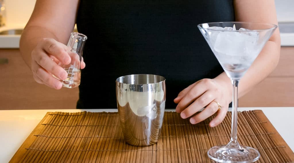 pouring vermouth in cocktail shaker