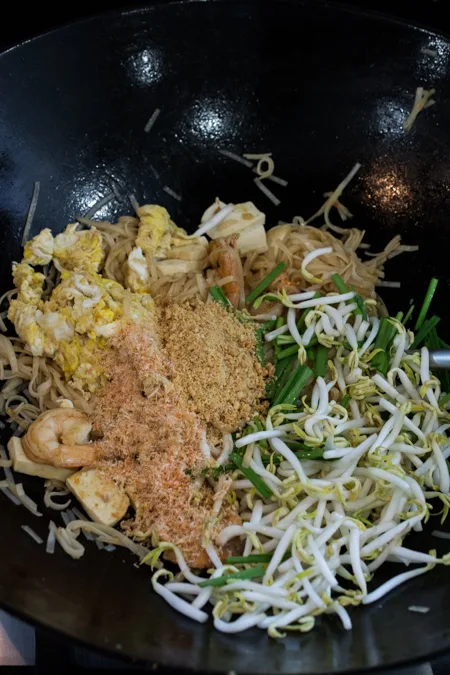 Authentic Pad Thai made easy! Rice noodles stir-fried in a slightly sweet and tangy sauce, topped with shrimp, sliced tofu, ground roasted peanuts, and fresh bean sprouts.