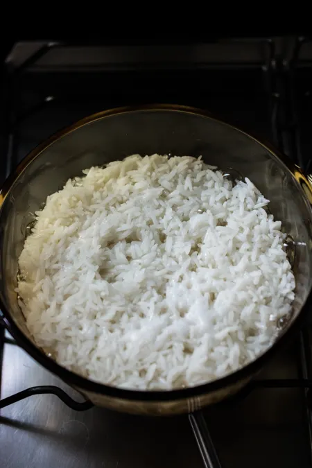 craters on the surface of rice on the stovetop