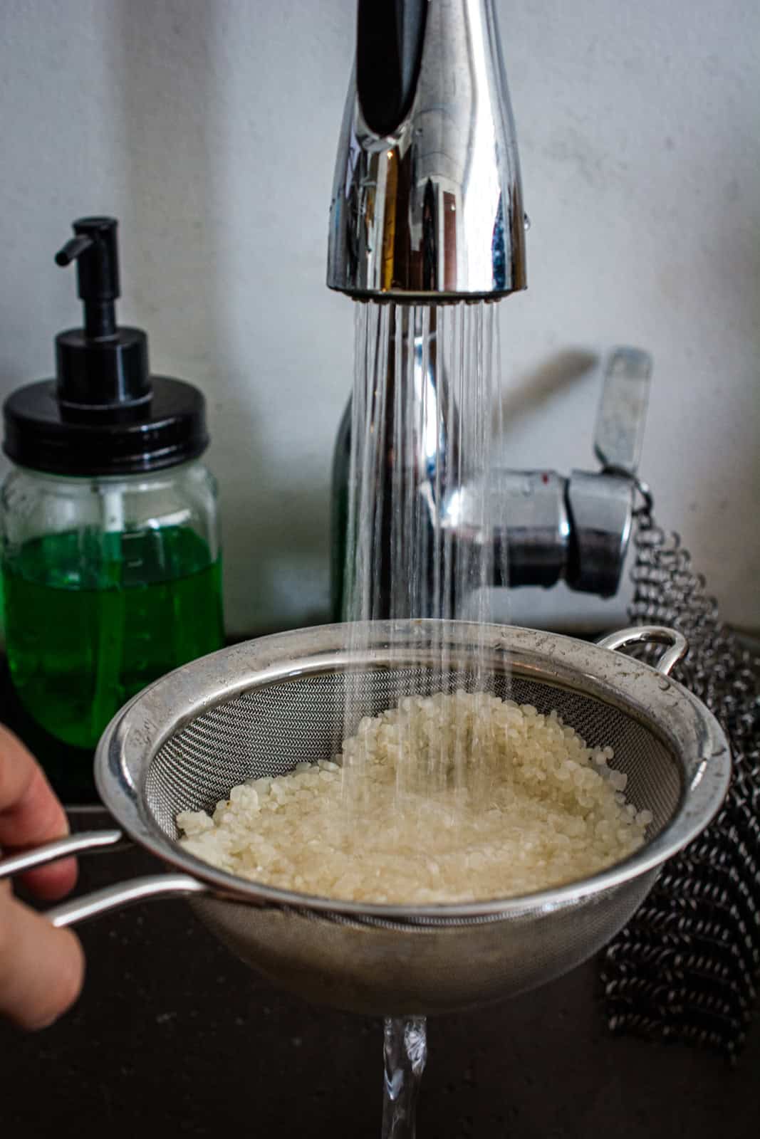 rinsing rice in a sieve