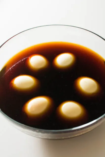 Half-Boiled Ajitama (Seasoned Ramen Eggs) have slightly firm egg whites and luscious custard-like yolks. The sweet soy seasoning gives them unbelievable flavor. Famously used as a topping for ramen but can be enjoyed as a snack anytime.