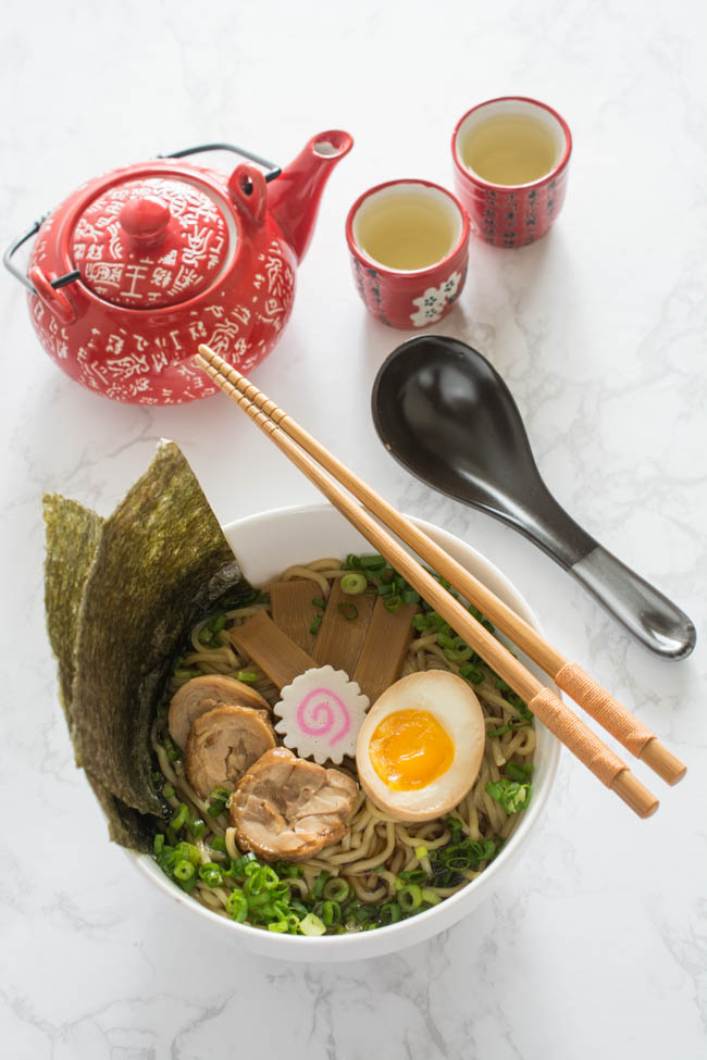 Traditional Shoyu Ramen features a savory soy-sauce based clear broth and ramen noodles with classic toppings such as chashu, seasoned bamboo shoots, and a half-boiled seasoned egg.