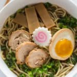 Traditional Shoyu Ramen features a savory soy-sauce based clear broth and ramen noodles with classic toppings such as chashu, seasoned bamboo shoots, and a half-boiled seasoned egg.