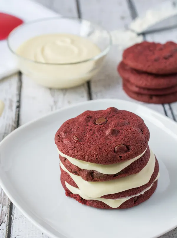 These Red Velvet Chocolate Chip Cookies are awesome enough on their own, but add the Cream Cheese Frosting and it takes the cookie to a whole new level of YUM!