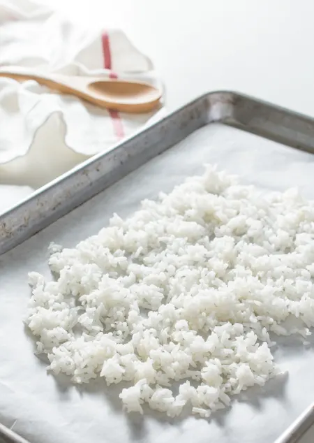 cooked white rice on a baking sheet