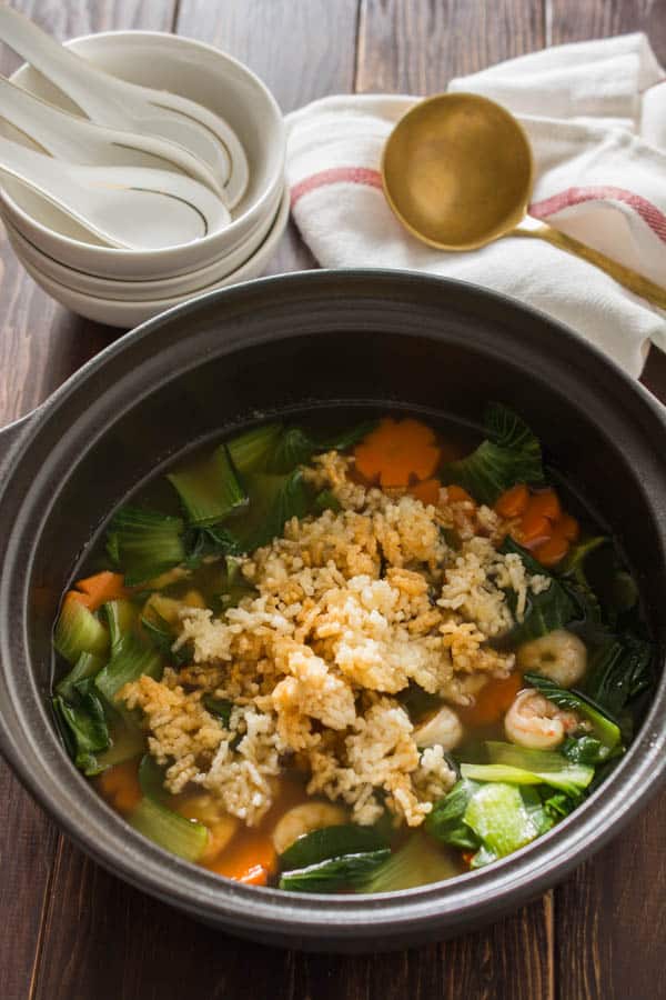 sizzling rice soup with bowls and a ladle