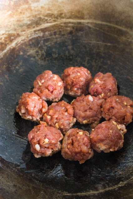 ground pork meatballs in a wok