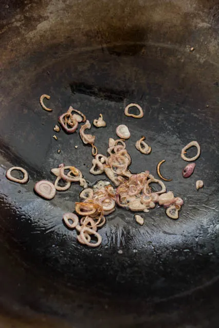 sliced shallots in wok