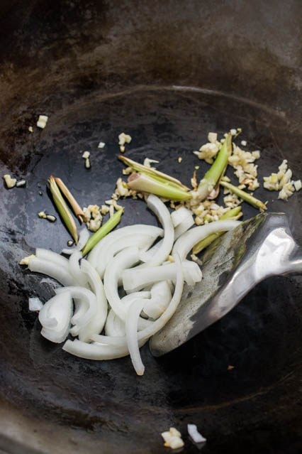 sliced onions, chopped garlic and lemongrass in wok