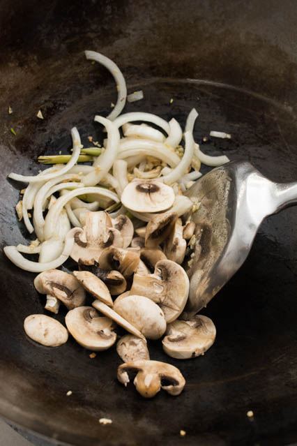 mushrooms, onion, lemongrass and garlic in wok