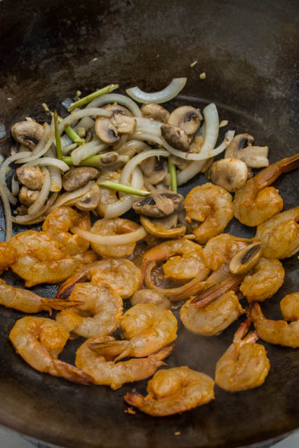 shrimp, mushrooms, lemongrass and onion in wok