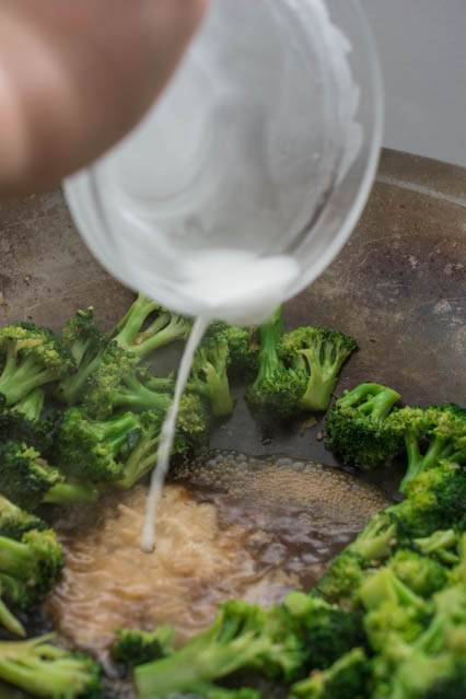 pouring the cornstarch in to beef and broccoli sauce