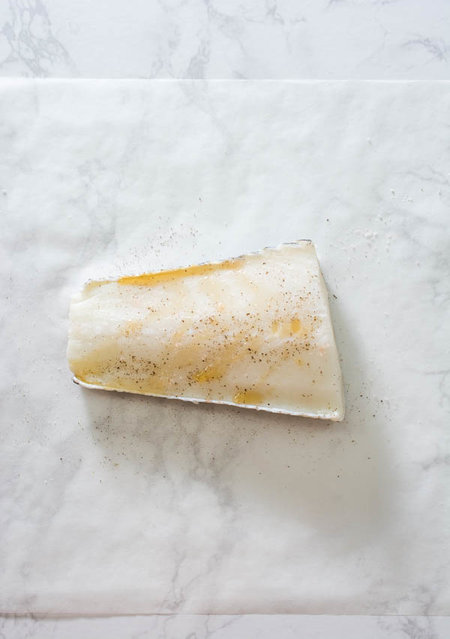 white fish fillet on parchment paper