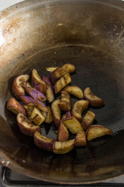 stir fried eggplant in a wok