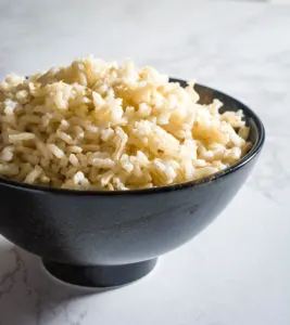 brown rice in black bowl