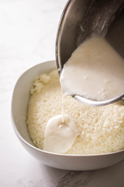 pouring coconut cream over glutinous rice