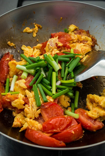 chinese egg and tomato in a wok with scallions