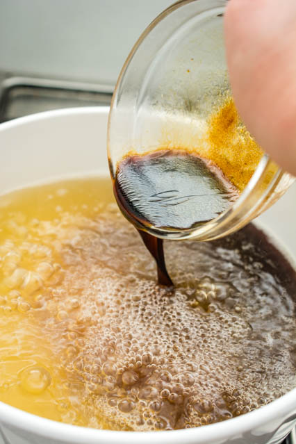 pouring sauce mixture to hot and sour soup