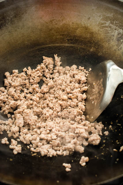 ground pork in a wok for pad kee mao