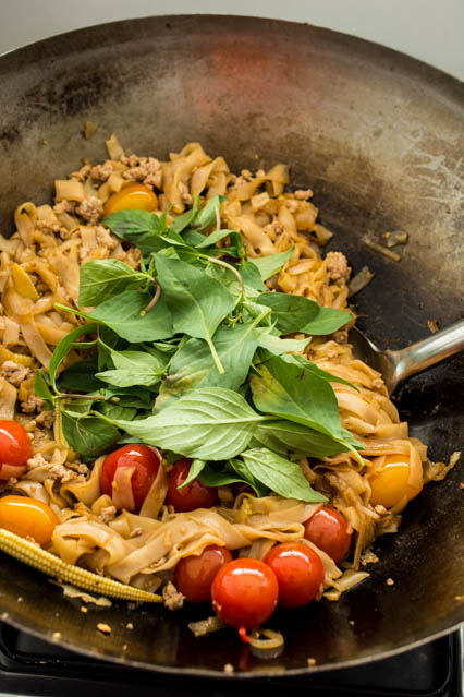 pad kee mao noodles in a wok
