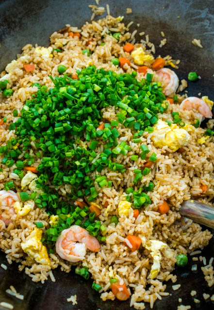 shrimp fried rice with scallions in wok