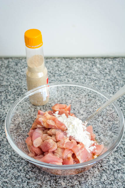 chicken marinating in cornstarch and white pepper 