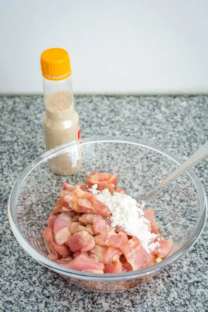 chicken marinating in cornstarch and white pepper