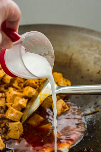 pouring cornstarch in to mapo tofu sauce