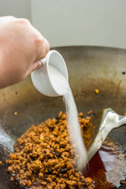 pouring sugar in to mapo tofu sauce