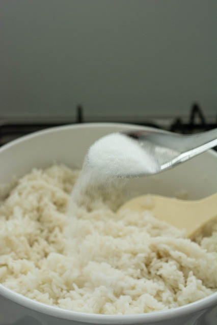 pouring sugar over nasi lemak