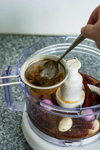 pressing tamarind juice for nasi lemak sambal