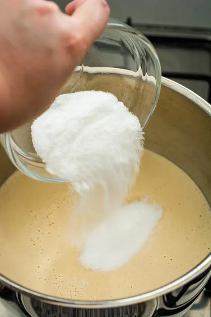 pouring sugar into sweet peanut cream