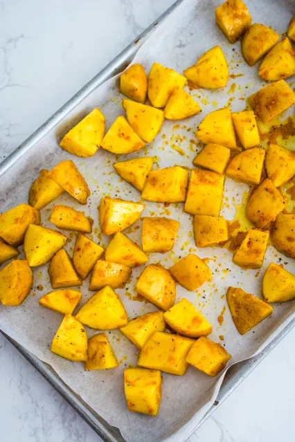 thai yellow curry potatoes on baking sheet