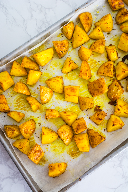 thai yellow curry roasted potatoes on baking sheet