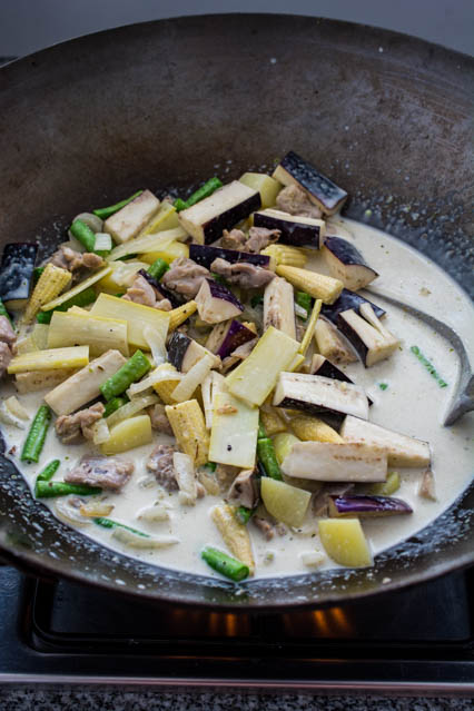 Thai green curry ingredients in wok