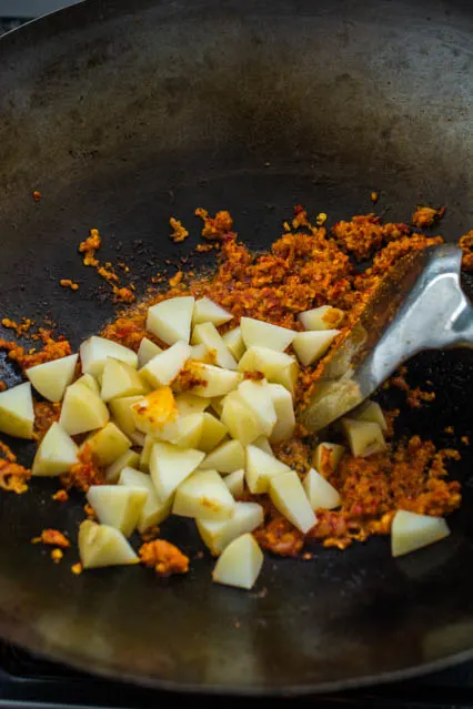 potatoes and sambal paste in wok