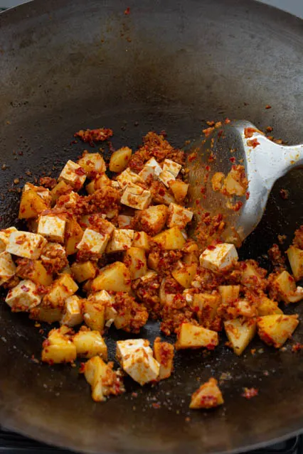 tofu and potato coated in sambal paste for malaysian fried noodles