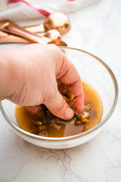 squeezing tamarind pulp