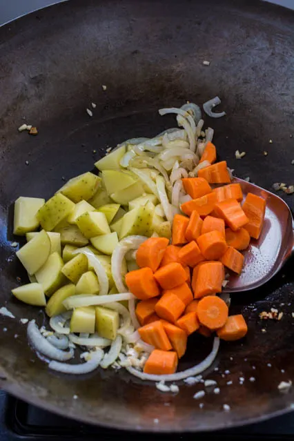 potatoes and carrots in a wok