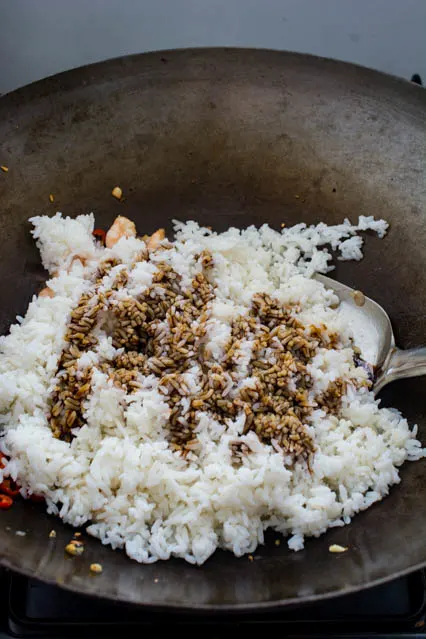 kecap manis on rice in a wok