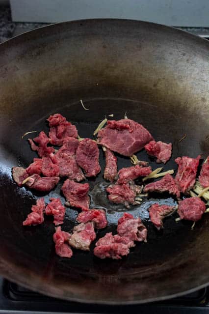 searing beef in a wok