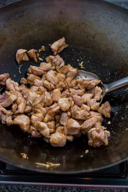 stir-frying ginger sesame chicken in wok